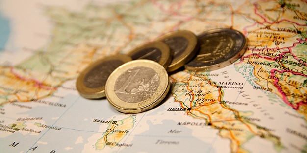 Euros on top of a map of Europe. Photo