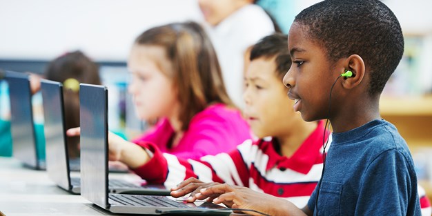 Pupils working at computers. Photo