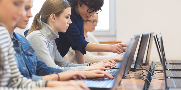 Studenter som arbetar vid datorer. Foto